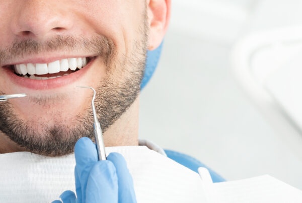 Young man at the dentist. Dental care, taking care of teeth. Regular Dental Cleaning