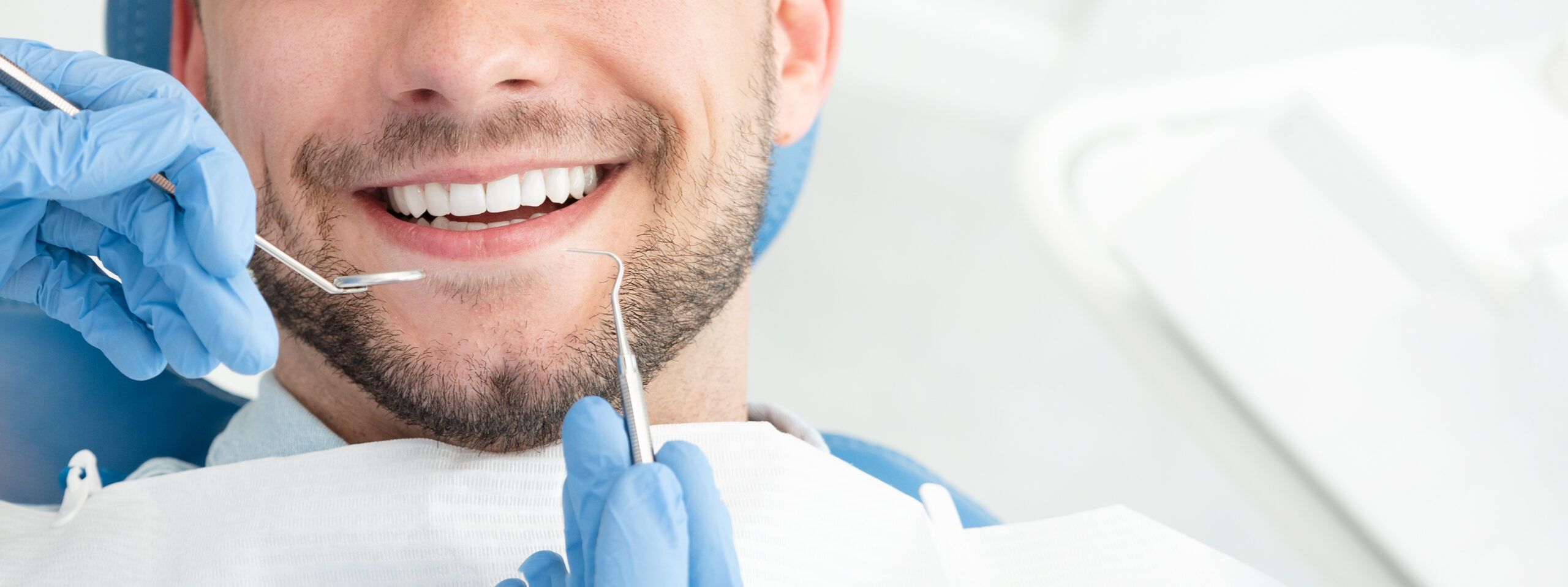 Young man at the dentist. Dental care, taking care of teeth. Regular Dental Cleaning